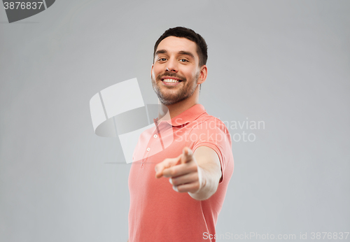 Image of man pointing finger to you over gray background