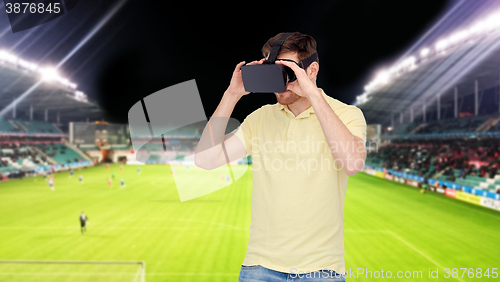 Image of man in virtual reality headset over football field