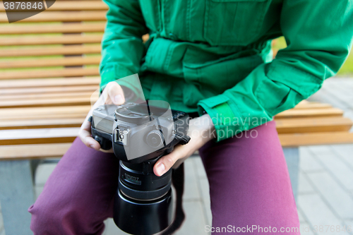 Image of close up of male photographer with digital camera