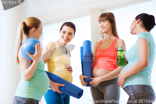 Image of group of happy pregnant women talking in gym
