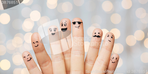 Image of close up of hands and fingers with smiley faces