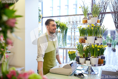 Image of florist man or seller at flower shop counter