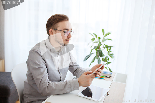 Image of creative male office worker texting on smarphone
