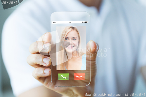 Image of close up of hand with incoming call on smartphone