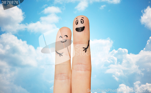 Image of close up of two fingers with smiley faces