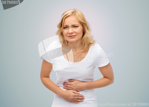 Image of unhappy woman suffering from stomach ache