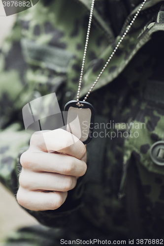 Image of close up of young soldier in military uniform