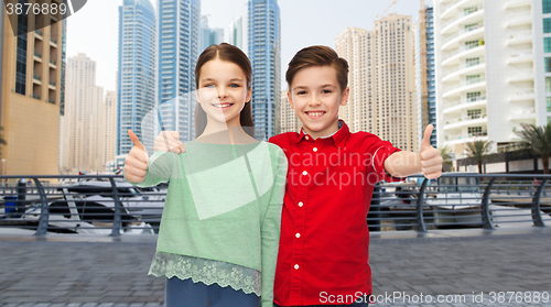 Image of happy boy and girl showing thumbs up