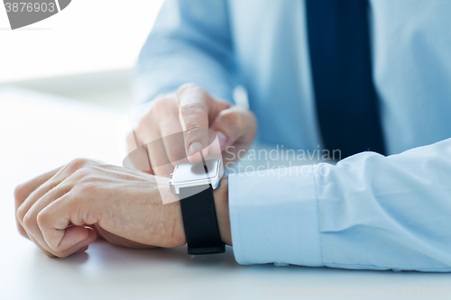 Image of close up of male hands setting smart watch