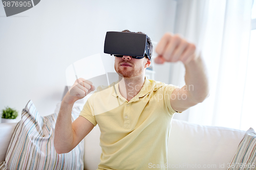 Image of young man in virtual reality headset or 3d glasses