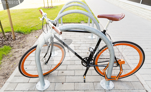 Image of close up of bicycle locked at street parking