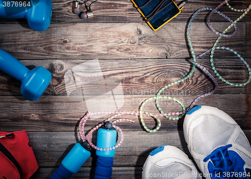 Image of Sport stuff on wooden table, top view