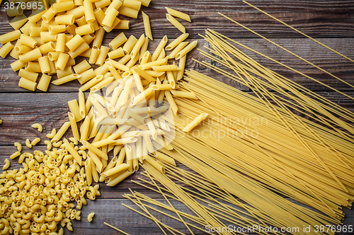 Image of close up portrait of raw homemade italian pasta, macaroni, spaghetti, and fettuccine