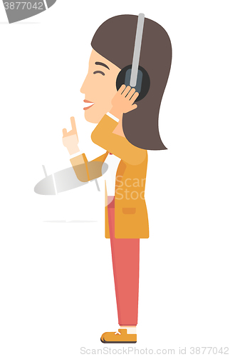 Image of Woman listening music in headphones 
