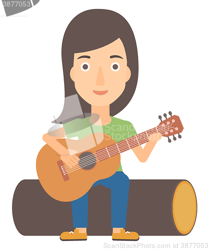 Image of Woman playing guitar.