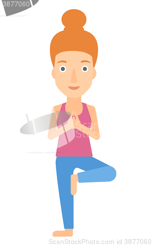 Image of Woman practicing yoga.