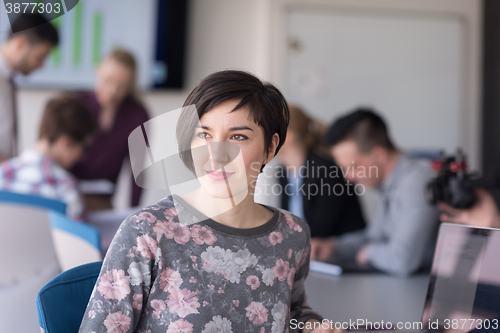 Image of portrait of young business woman at office with team on meeting 