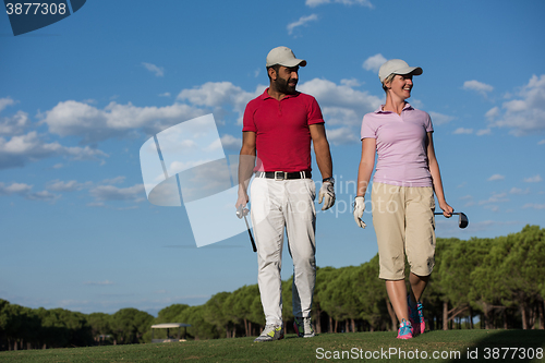 Image of couple walking on golf course