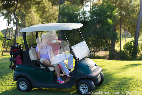 Image of couple in buggy on golf course