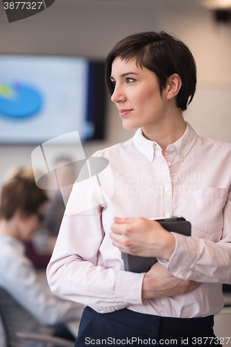 Image of hispanic businesswoman with tablet at meeting room