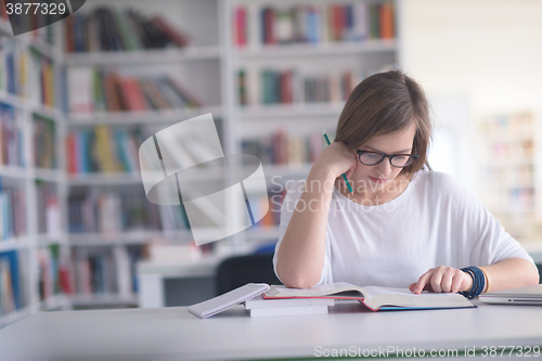 Image of female student study in school library