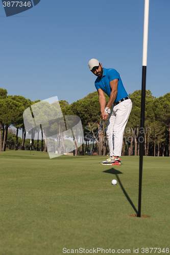 Image of golf player hitting shot at sunny day