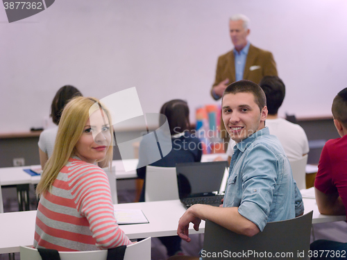 Image of teacher with a group of students in classroom
