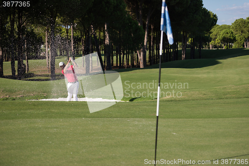 Image of golfer hitting a sand bunker shot