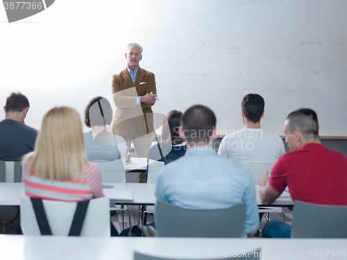 Image of teacher with a group of students in classroom