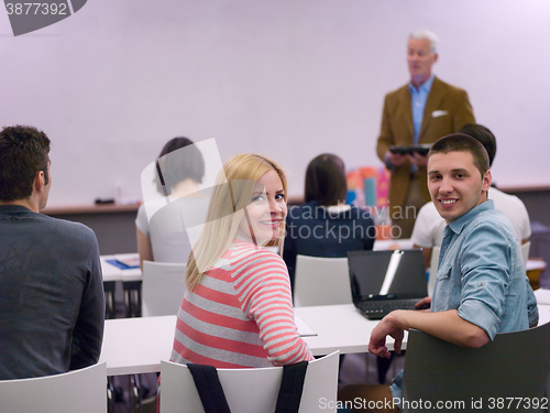 Image of teacher with a group of students in classroom