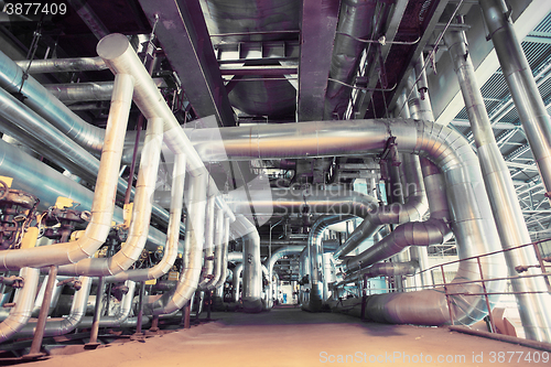 Image of different size and shaped pipes and valves at a power plant 