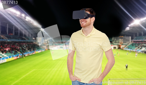 Image of man in virtual reality headset over football field