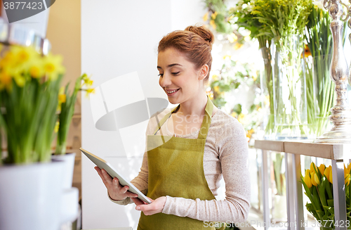 Image of woman with tablet pc computer at flower shop