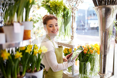 Image of woman with tablet pc computer at flower shop