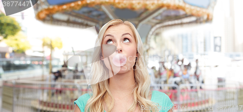 Image of happy young woman or teenage girl chewing gum