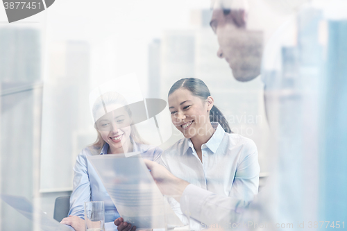 Image of group of smiling businesspeople meeting in office