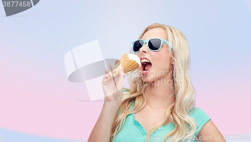 Image of happy young woman in sunglasses eating ice cream