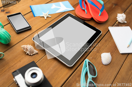 Image of close up of tablet pc and travel stuff