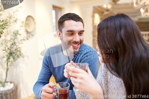 Image of happy couple drinking tea at cafe