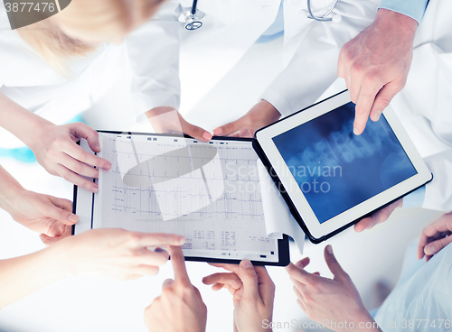 Image of group of doctors looking at x-ray on tablet pc