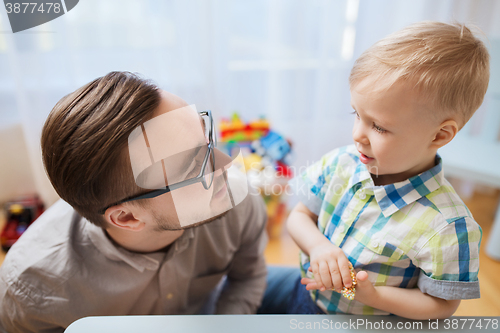 Image of father and son playing with ball clay at home