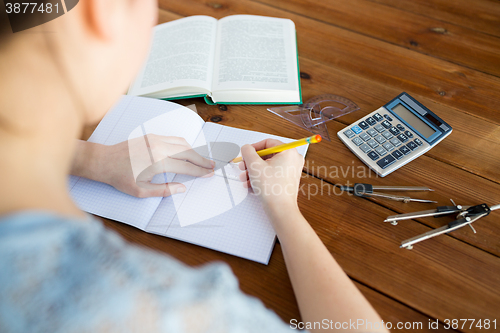 Image of close up of hands with ruler and pencil drawing