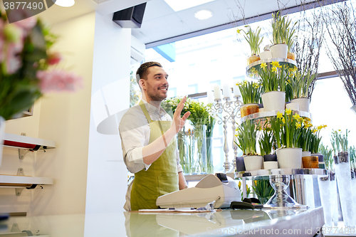 Image of florist man or seller at flower shop counter