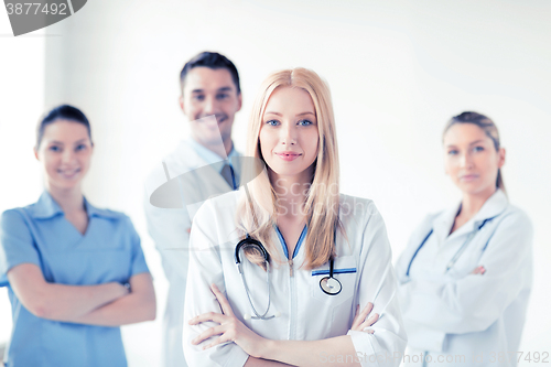 Image of female doctor in front of medical group