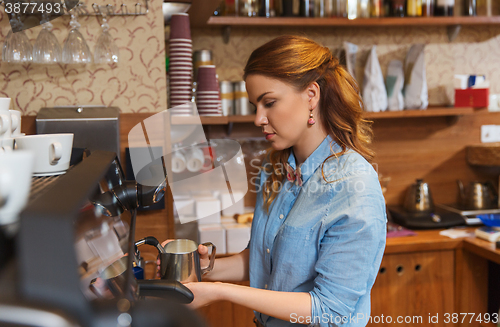 Image of barista woman making coffee by machine at cafe