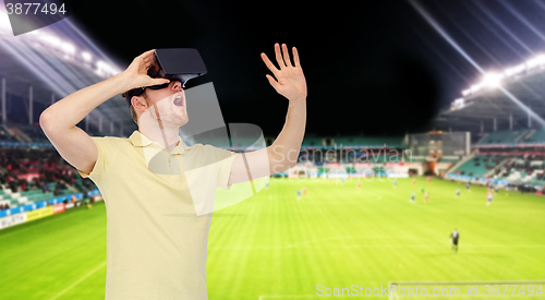 Image of man in virtual reality headset over football field