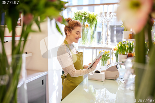 Image of woman with tablet pc computer at flower shop