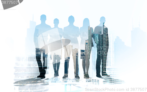 Image of business people silhouettes over city background