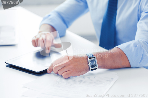 Image of businessman with tablet pc in office