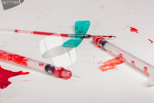 Image of Syringes and IV Lines Covered with Blood